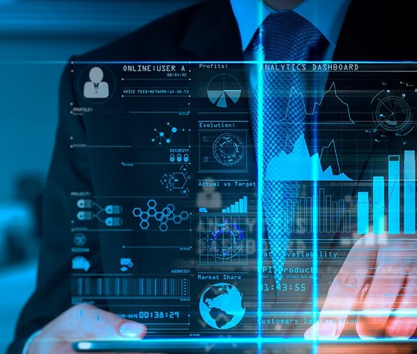 man-in-a-suit-standing-behind-a-hologram-of-data-analytics v2